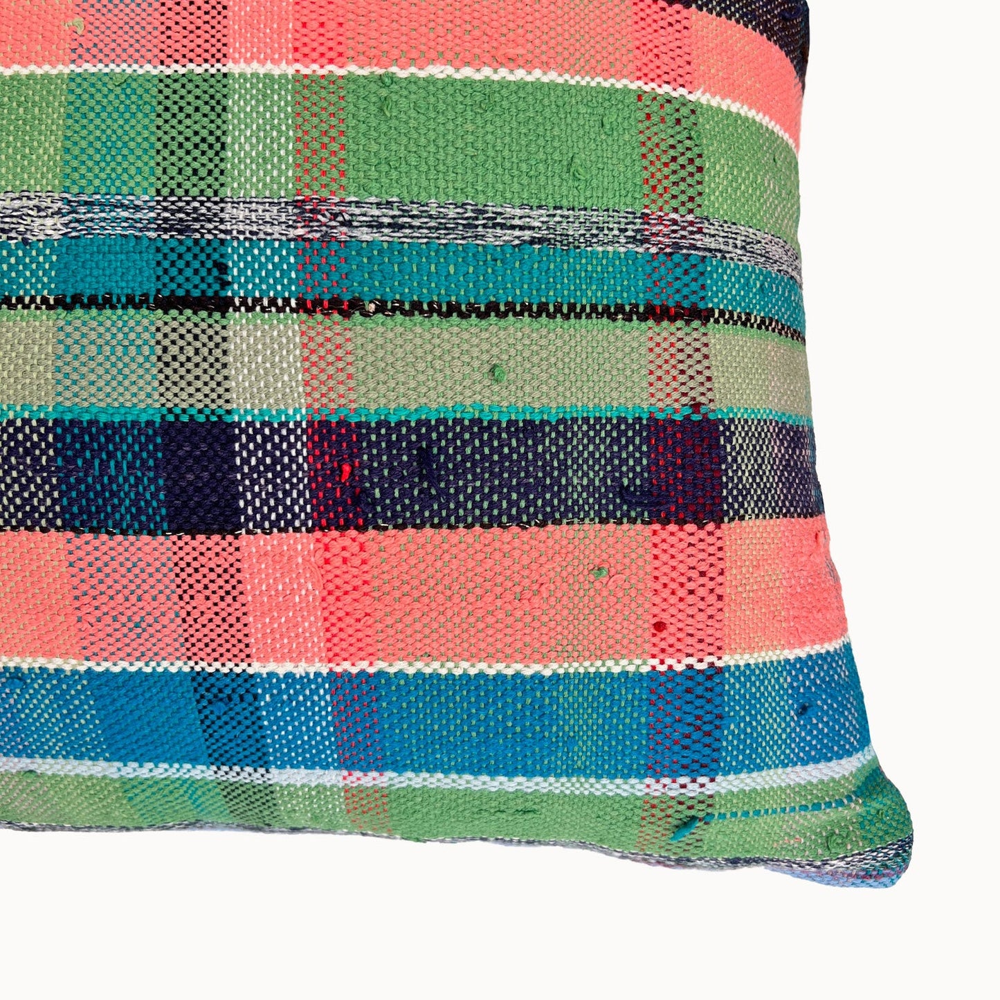 Multicolored plaid patterned pillow on a white background