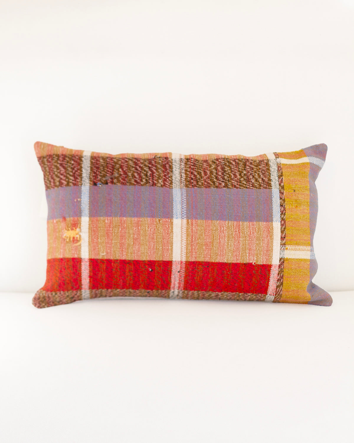 Colorful plaid pillow on a white background