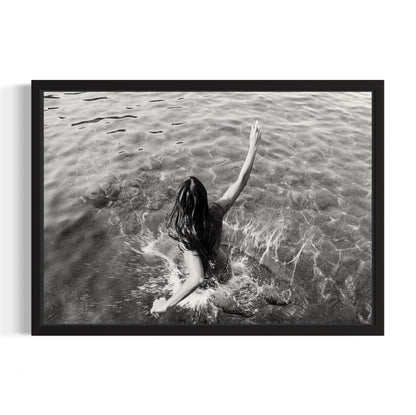 Black and white framed artwork of a person in water with one arm raised.