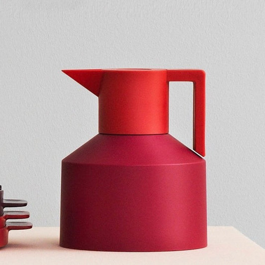 Red pitcher on a light gray background